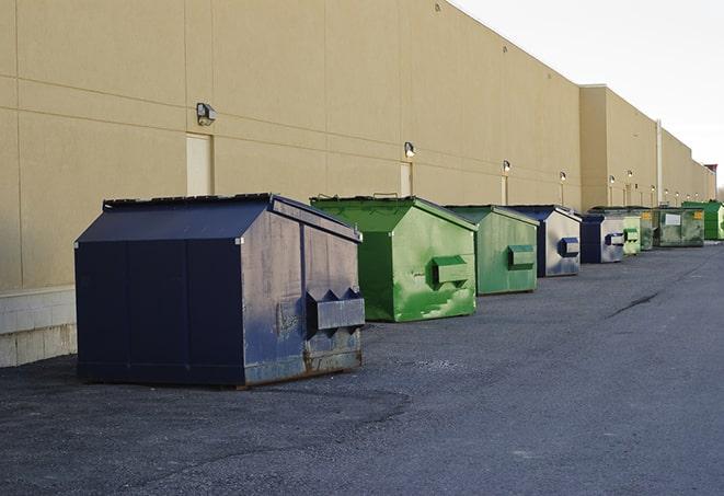 a group of dumpsters lined up along the street ready for use in a large-scale construction project in Capitola